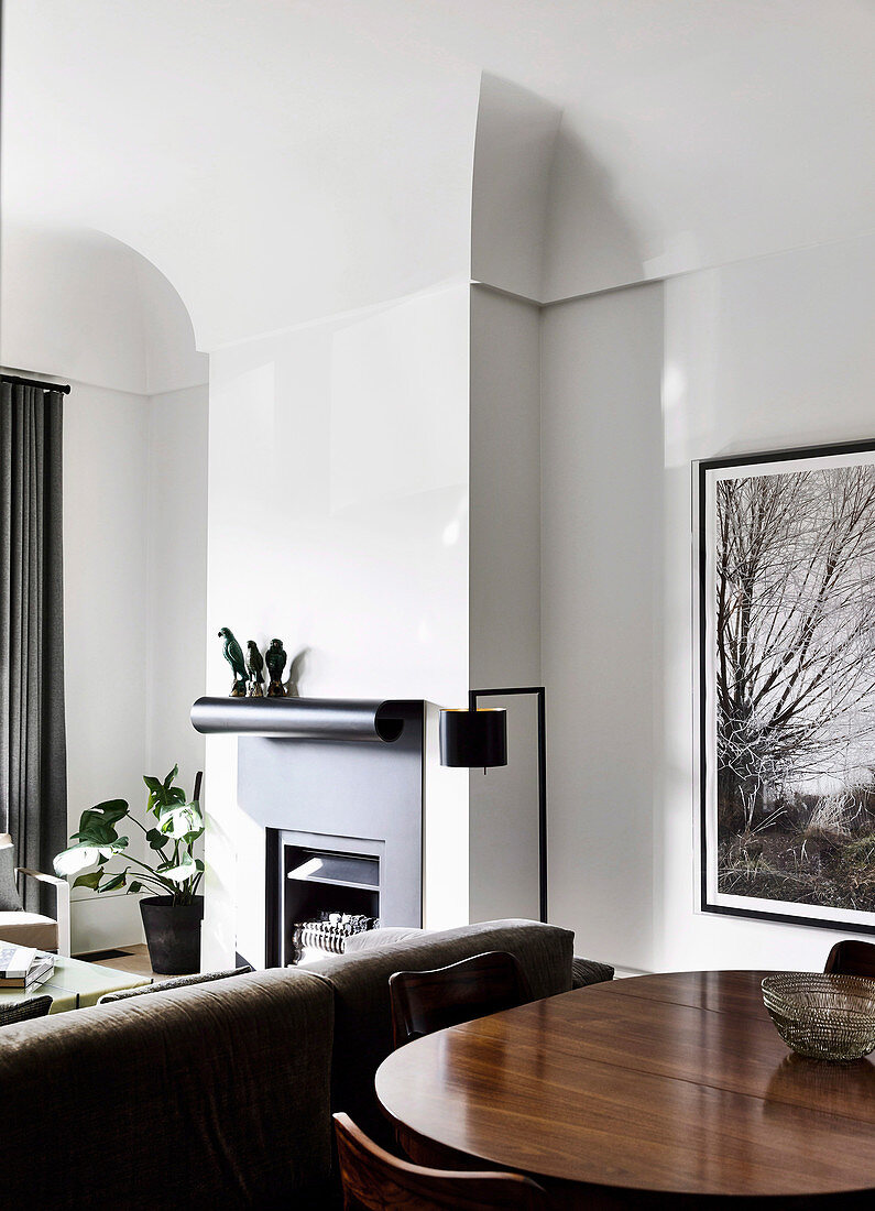 View over dining table into the living area with fireplace