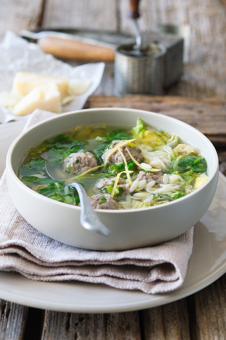 Clear broth with dumplings, noodles and vegetables