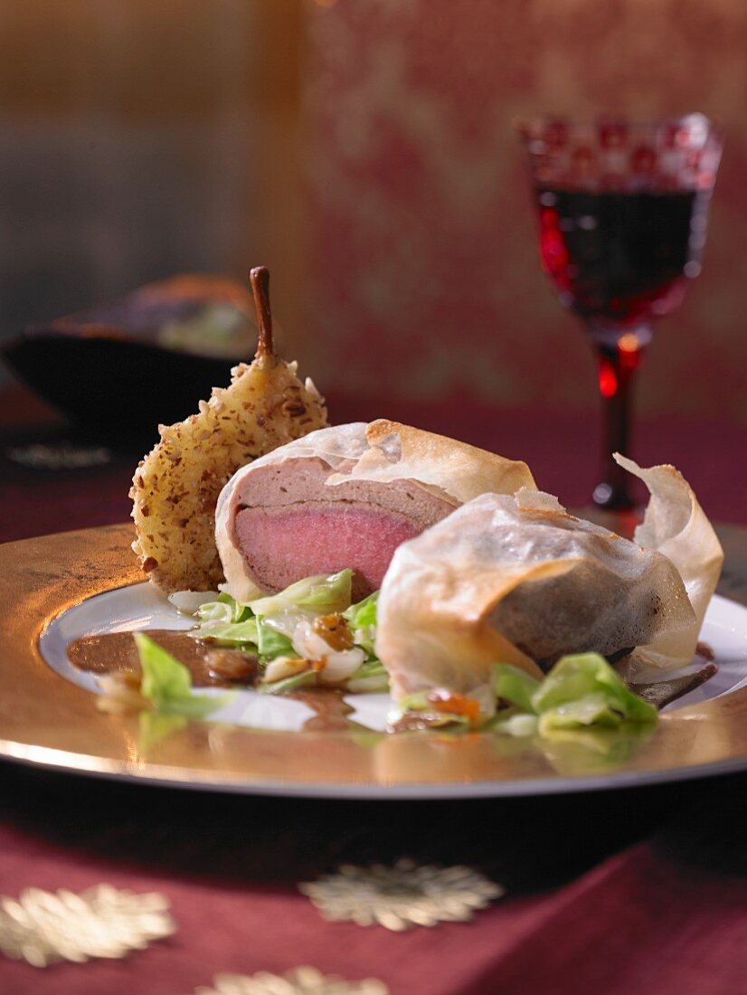 Roast wild boar in filo pastry with pointed cabbage and sour cream sauce (Christmas)