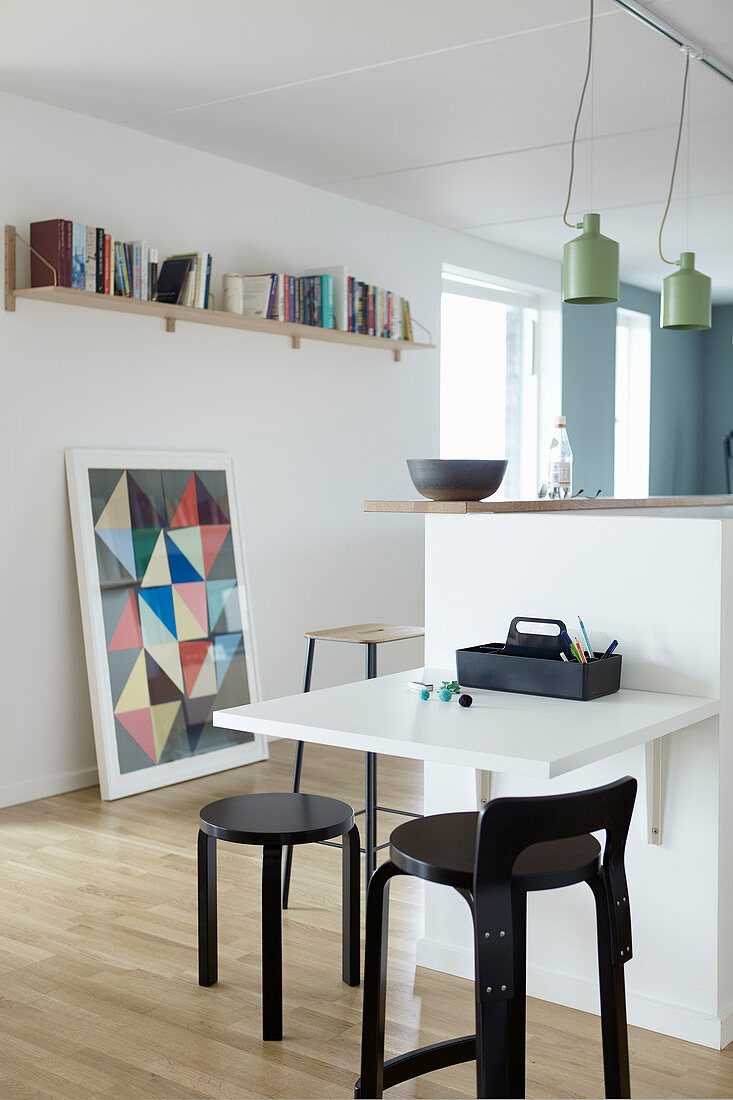 Child's table on end of half-height partition wall in kitchen