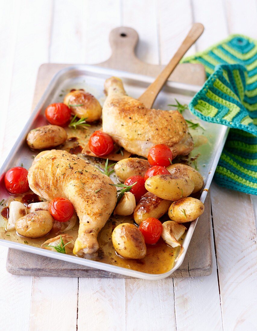 Chicken legs with potatoes and cherry tomatoes