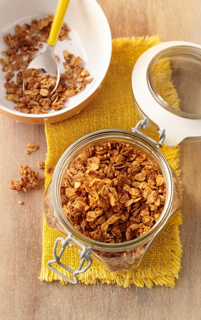 Crunchy muesli with oatmeal and almonds in a glass jar