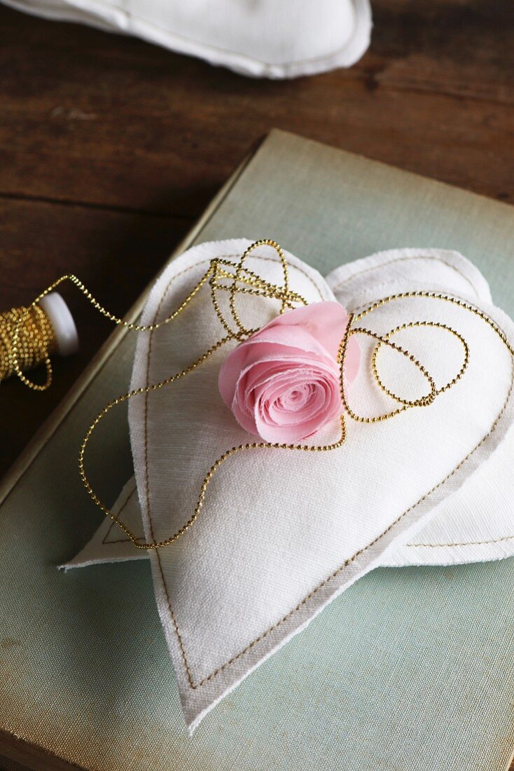 Silk flower on two hand-sewn fabric hearts