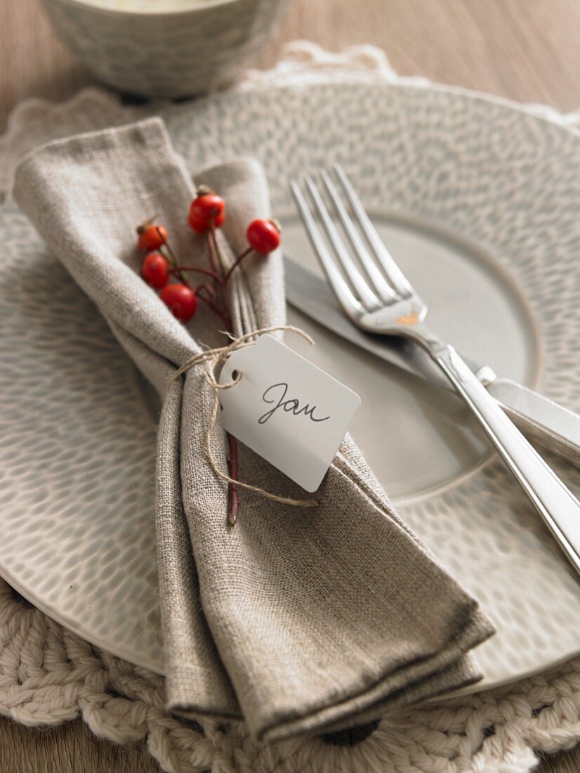 An Autumnal place setting with a serviette and a name tag