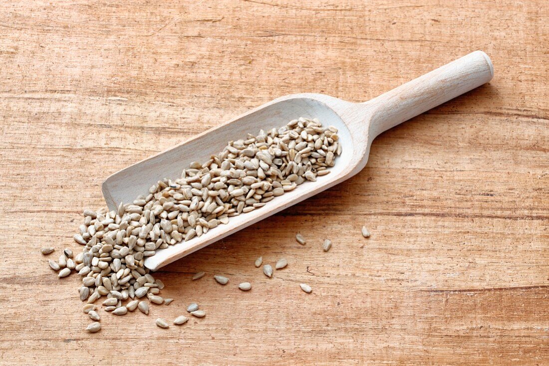 Sunflower seeds in a wooden scoop
