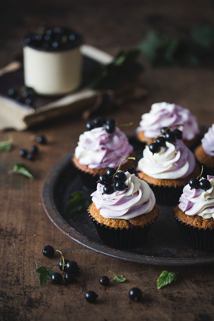 Blackcurrant and white chocolate cupcakes on a metal tray