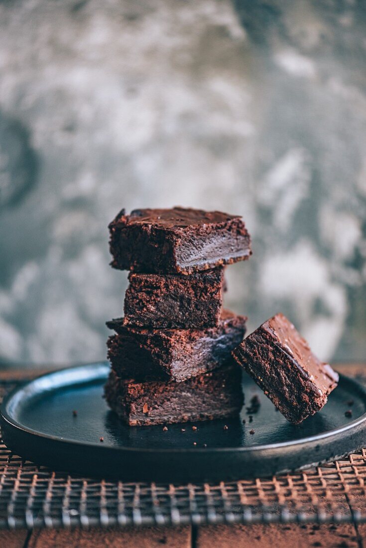 A stack of chocolate brownies on a plate