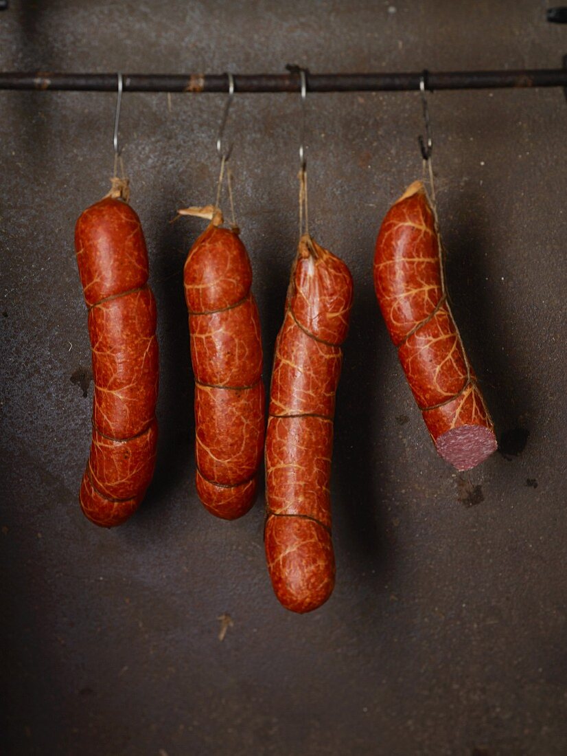 Susländer pork sausages hanging on hooks in a row