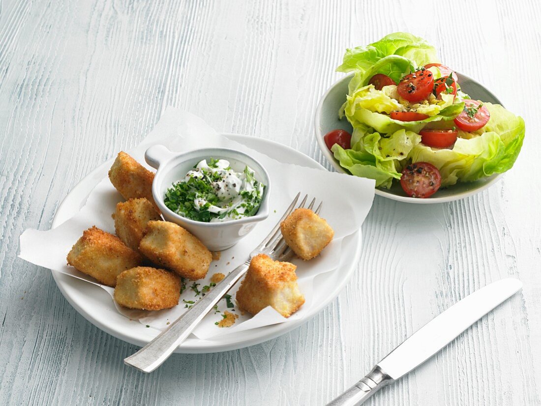 Chicken nuggets with a herb dip and salad