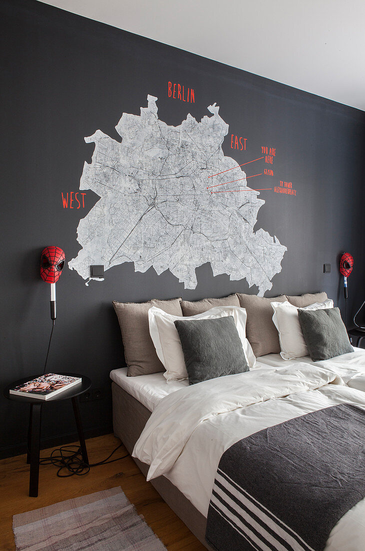 Stadtplan von Berlin an schwarzer Wand über dem Bett