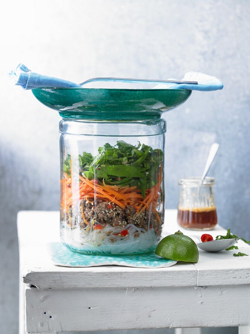 Glass noodle salad with beef mince and coriander in a glass jar