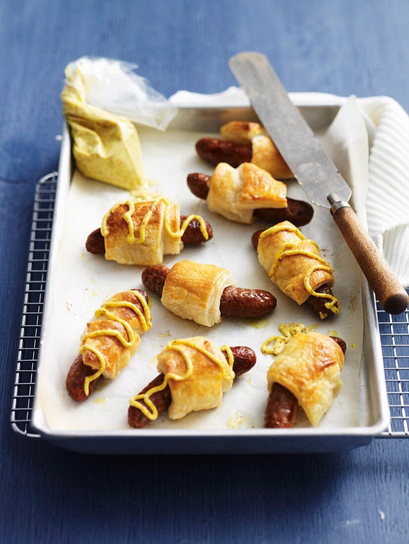 Sausages wrapped in puff pastry with mustard