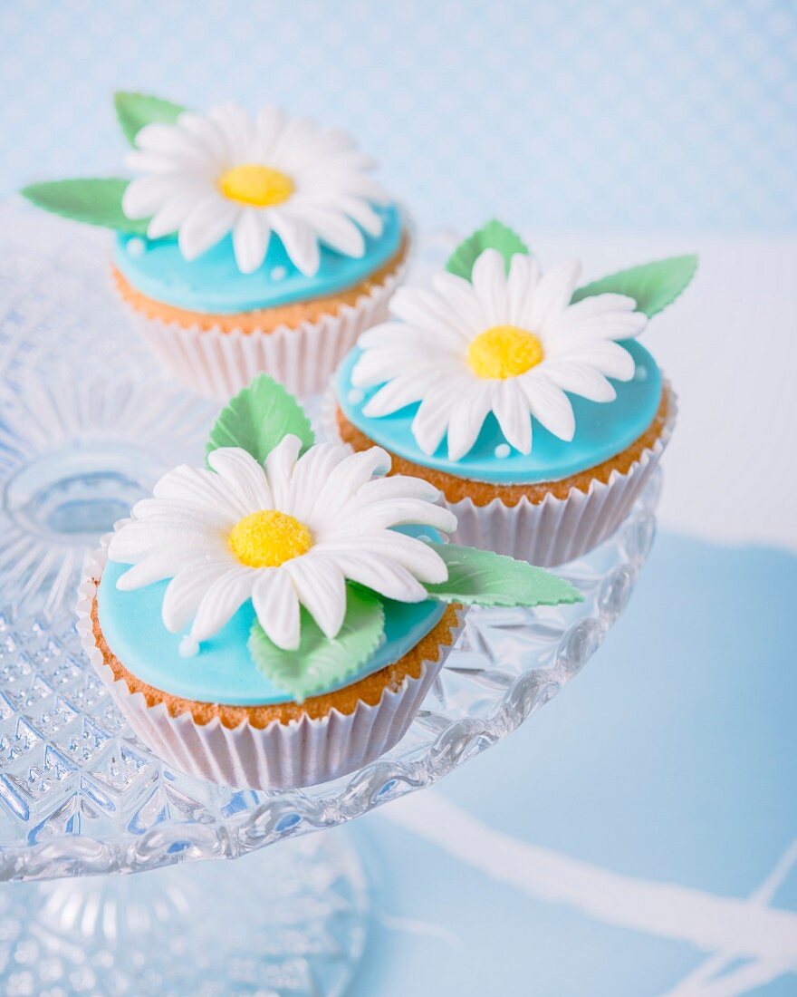 Cupcakes with fondant icing and sugar flowers on the top