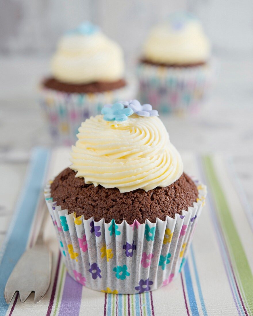 Chocolate cupcakes with buttercream and sugar flowers