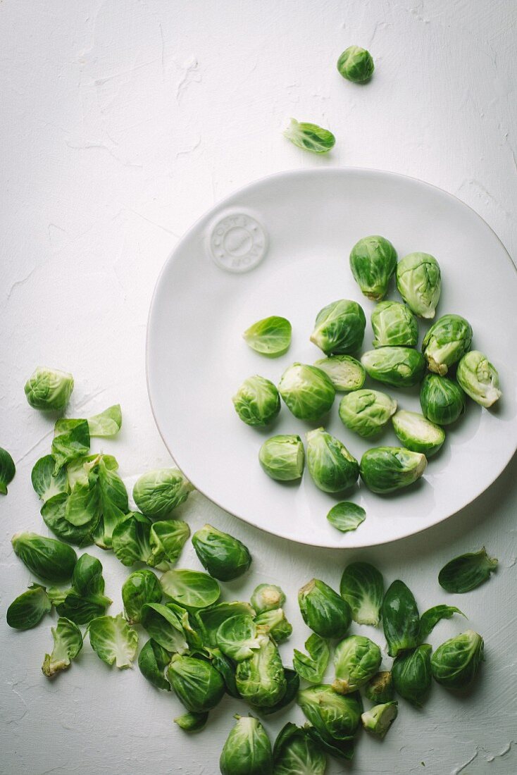 Brussel sprouts on white plate and white background