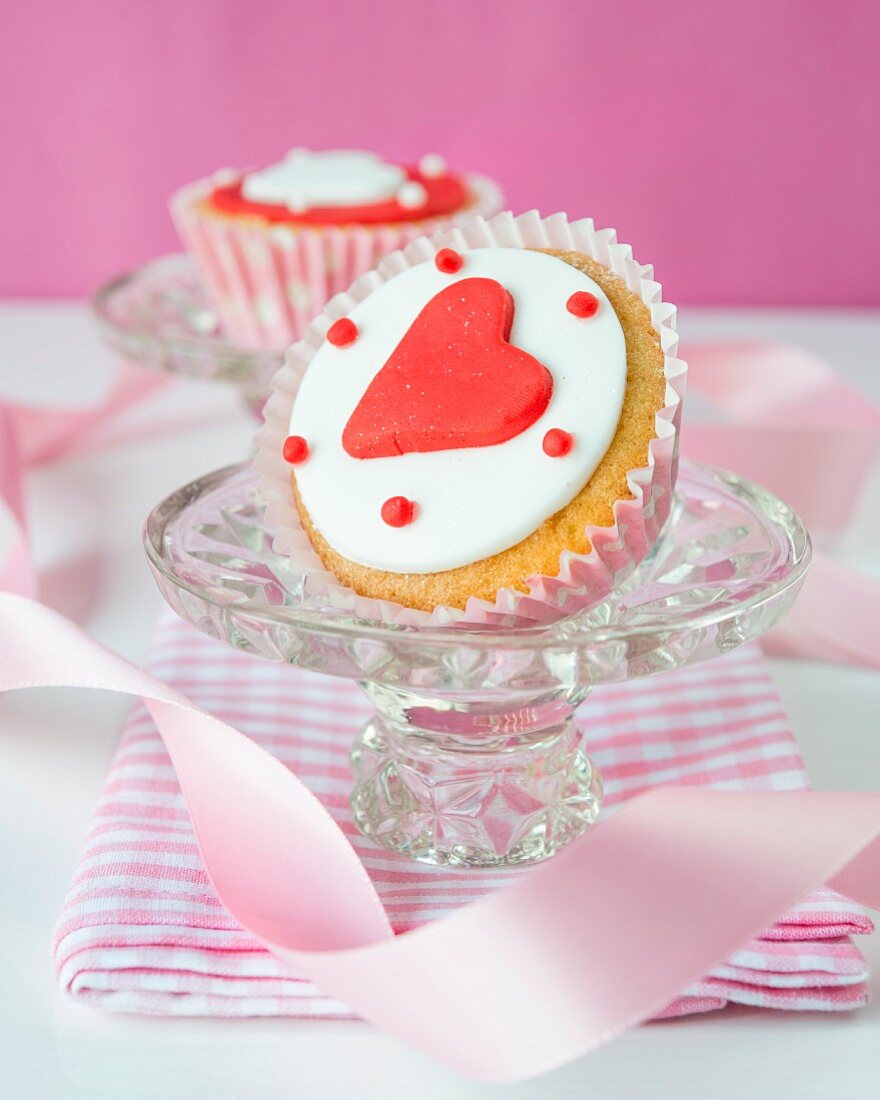 A cupcake decorated with a fondant heart