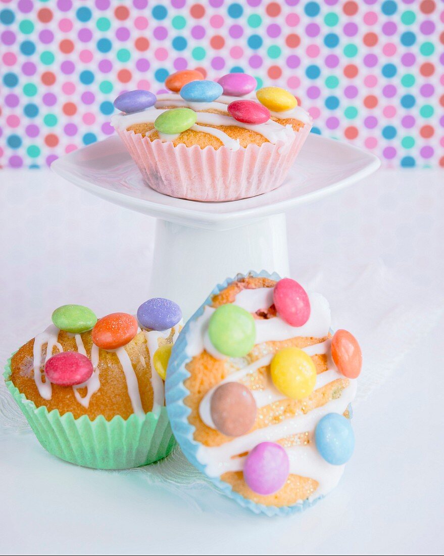 Cupcakes decorated with colourful chocolate beans