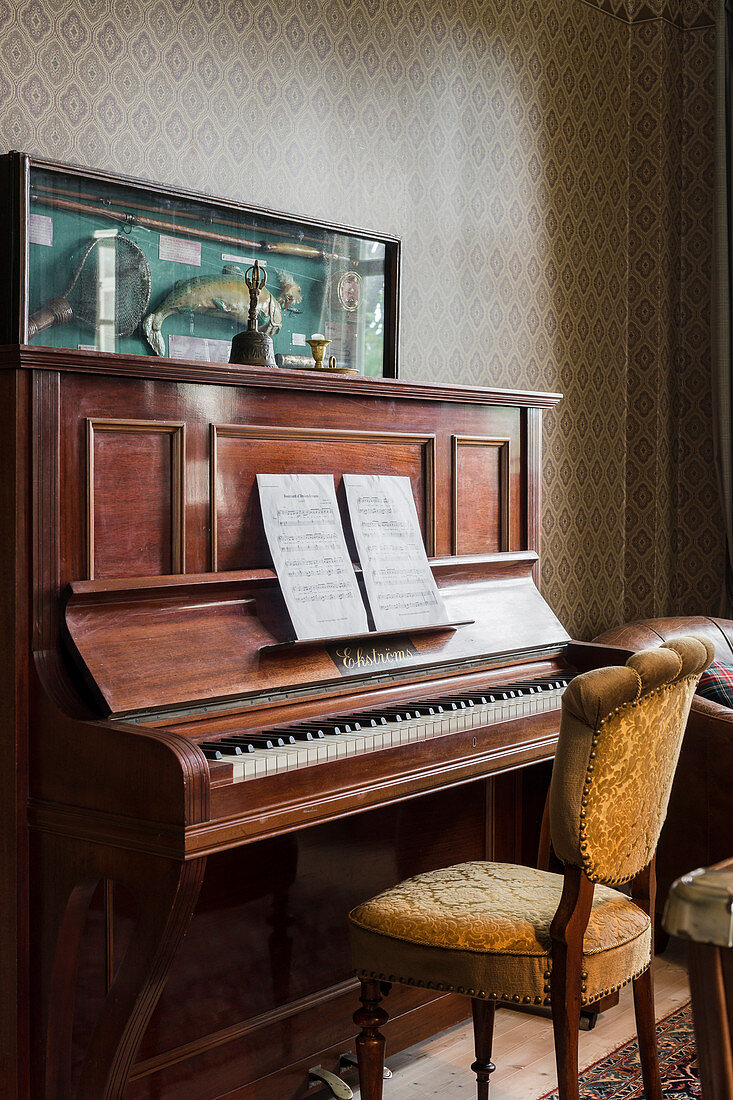 Old upholstered chair at a piano