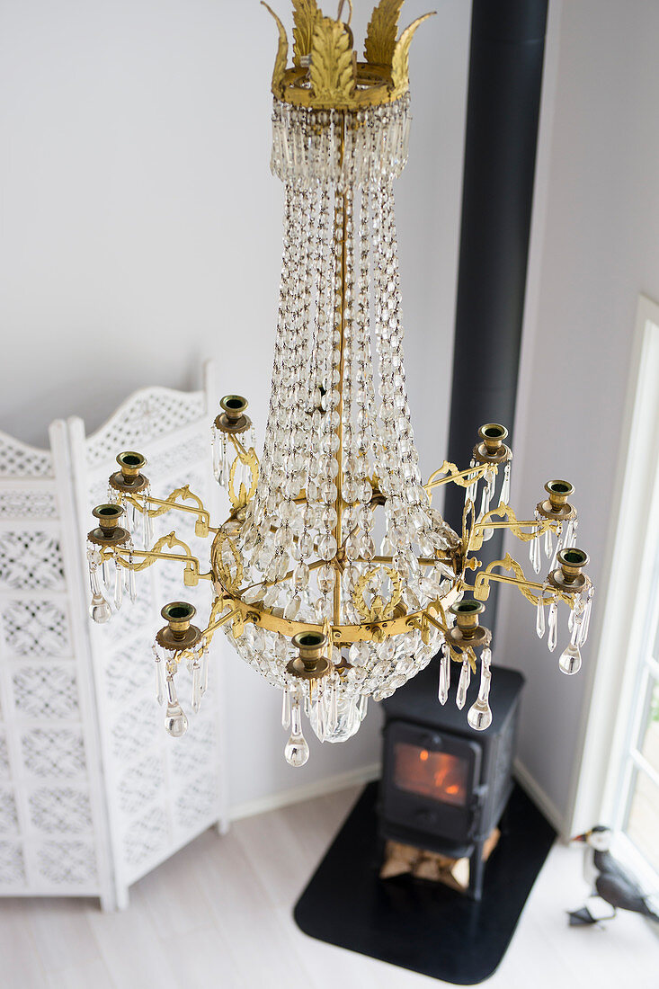 Chandelier, log-burner and screen in living room