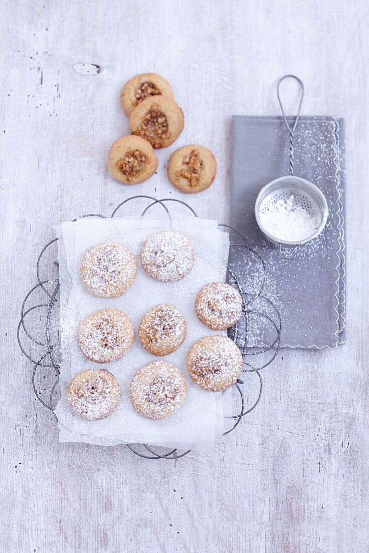 Walnut and orange cookies dusted with icing sugar