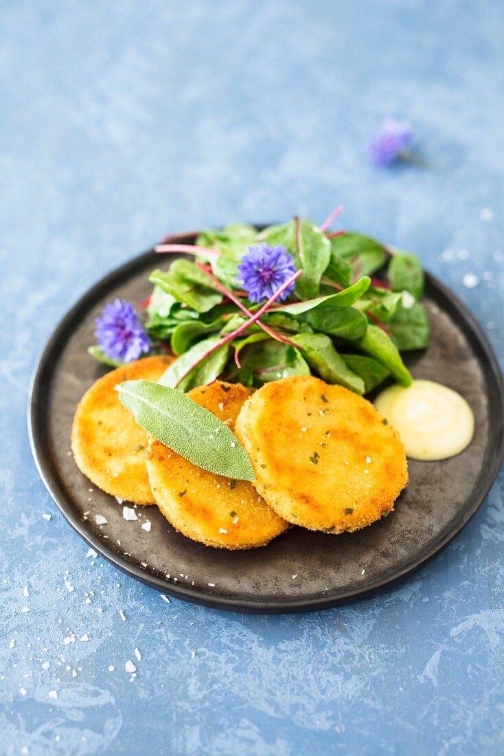 Baked kohlrabi slices with chard and edible flowers