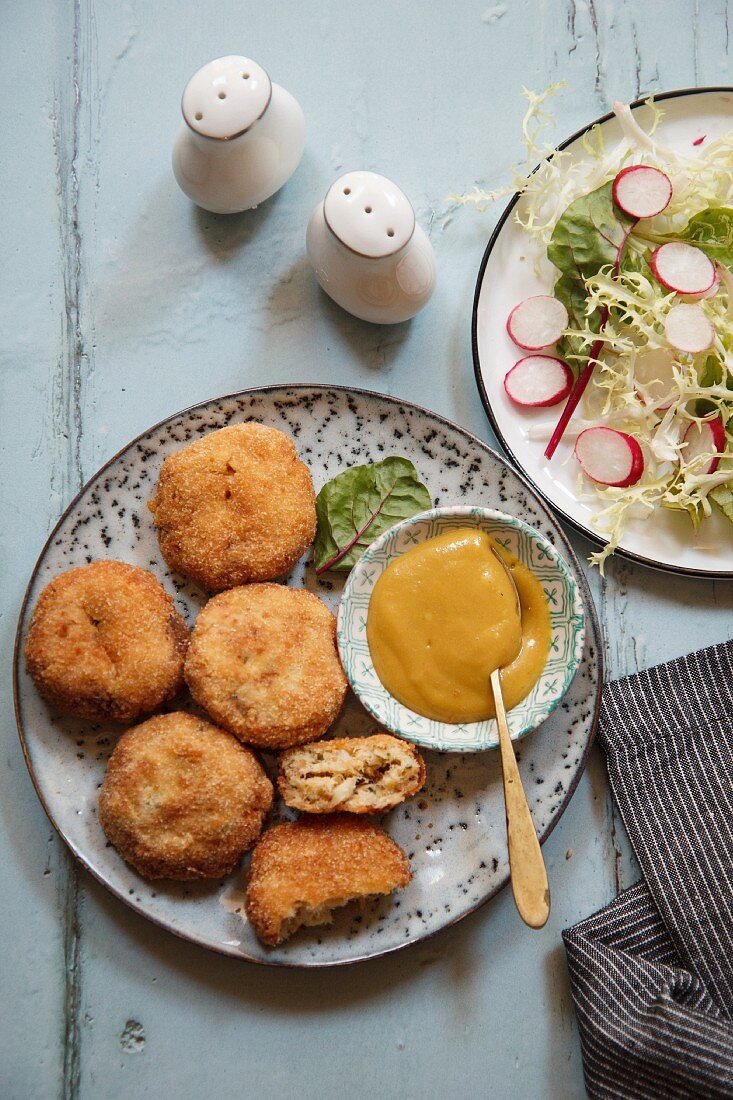 Fishcakes served with sauce and salad