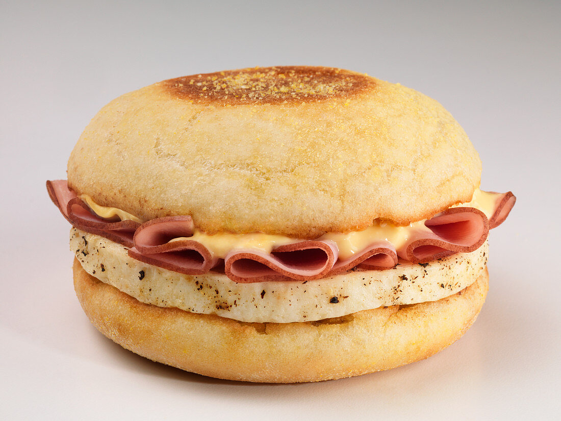 An English muffin with ham, egg and cheese