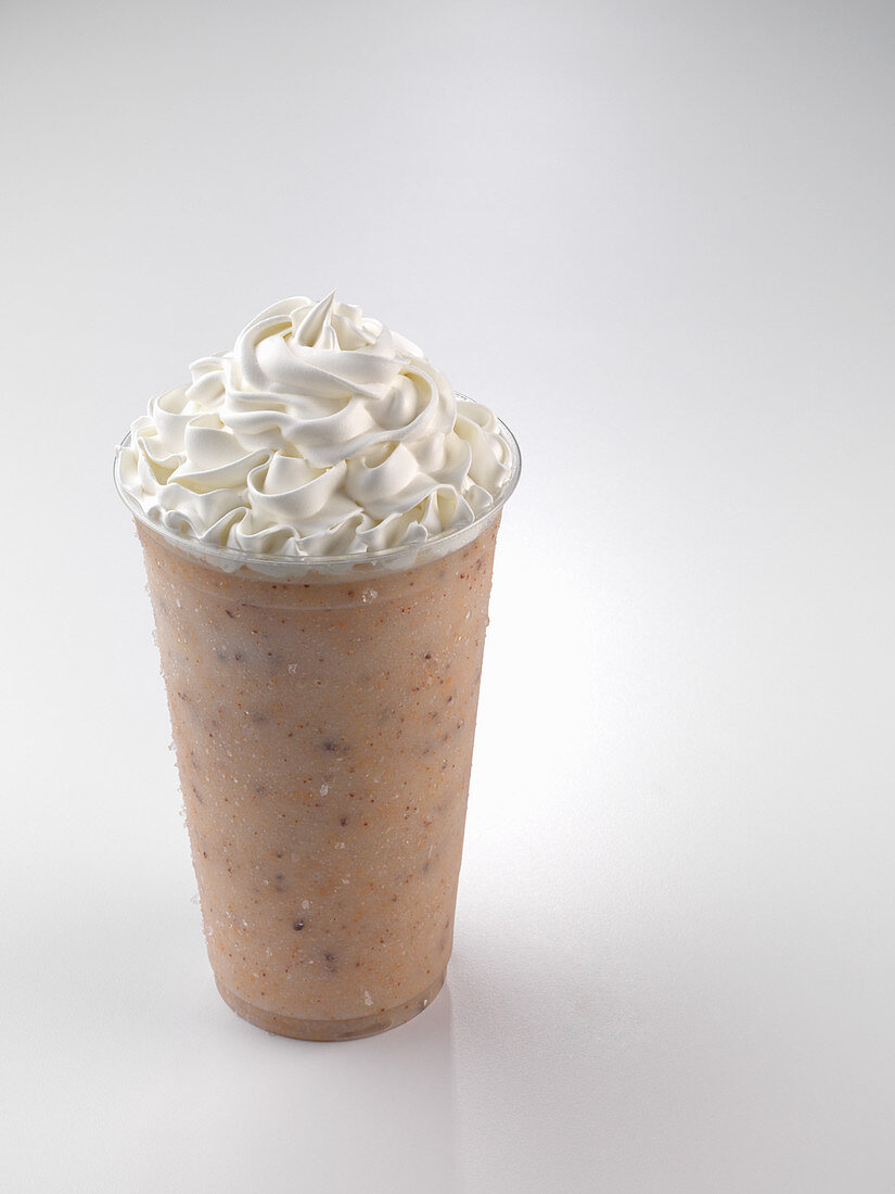 A smoothie topped with cream