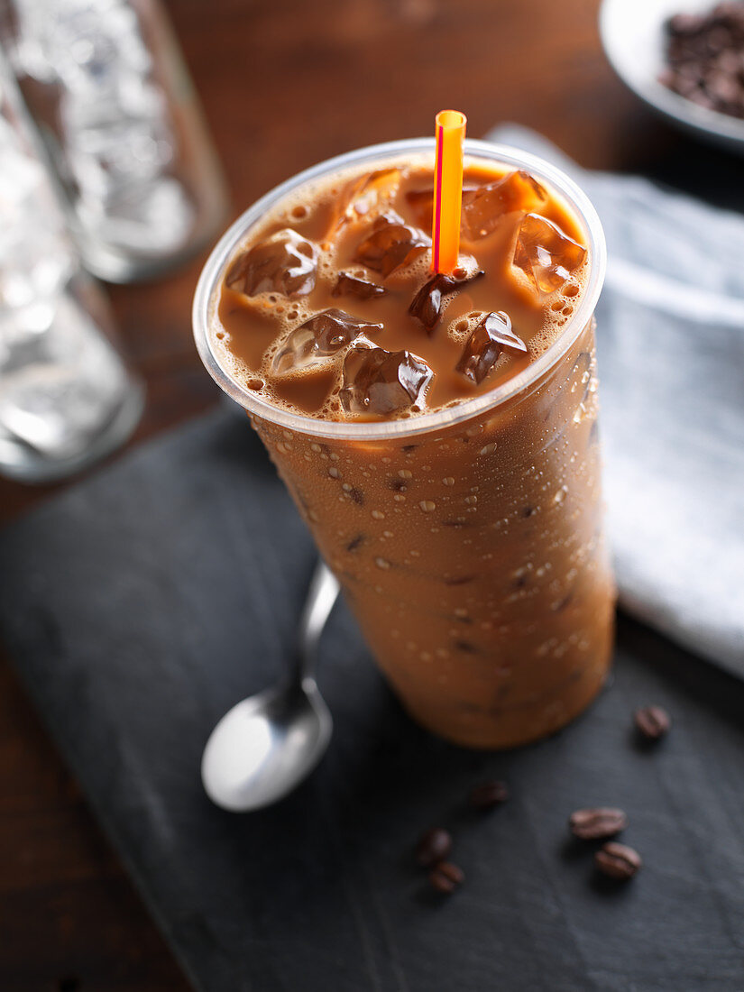 Iced Coffee in a Plastic Cup; Wrapped Straw