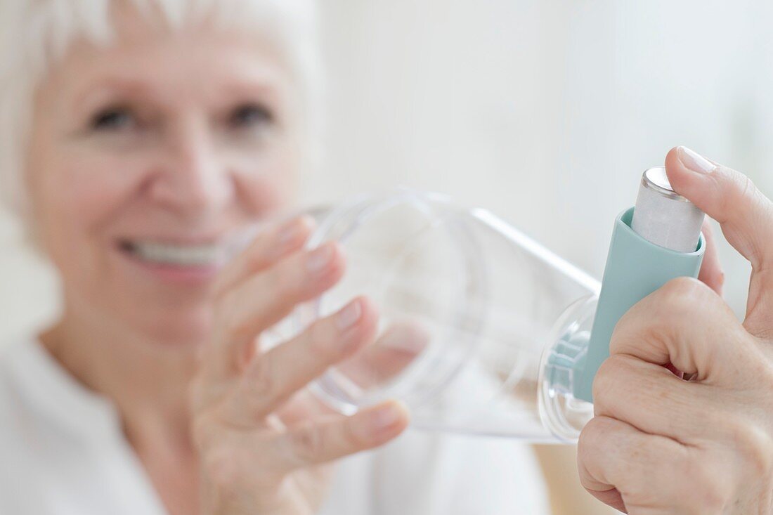 Senior woman holding inhaler