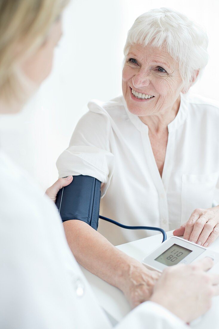 Senior woman having blood pressure taken