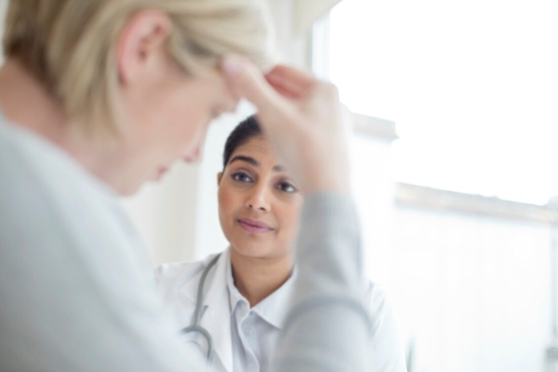 Female doctor listening to patient