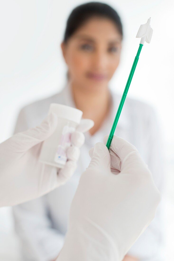 Doctor holding cervical smear equipment