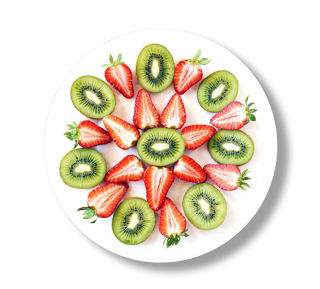Kiwis and strawberries on white plate