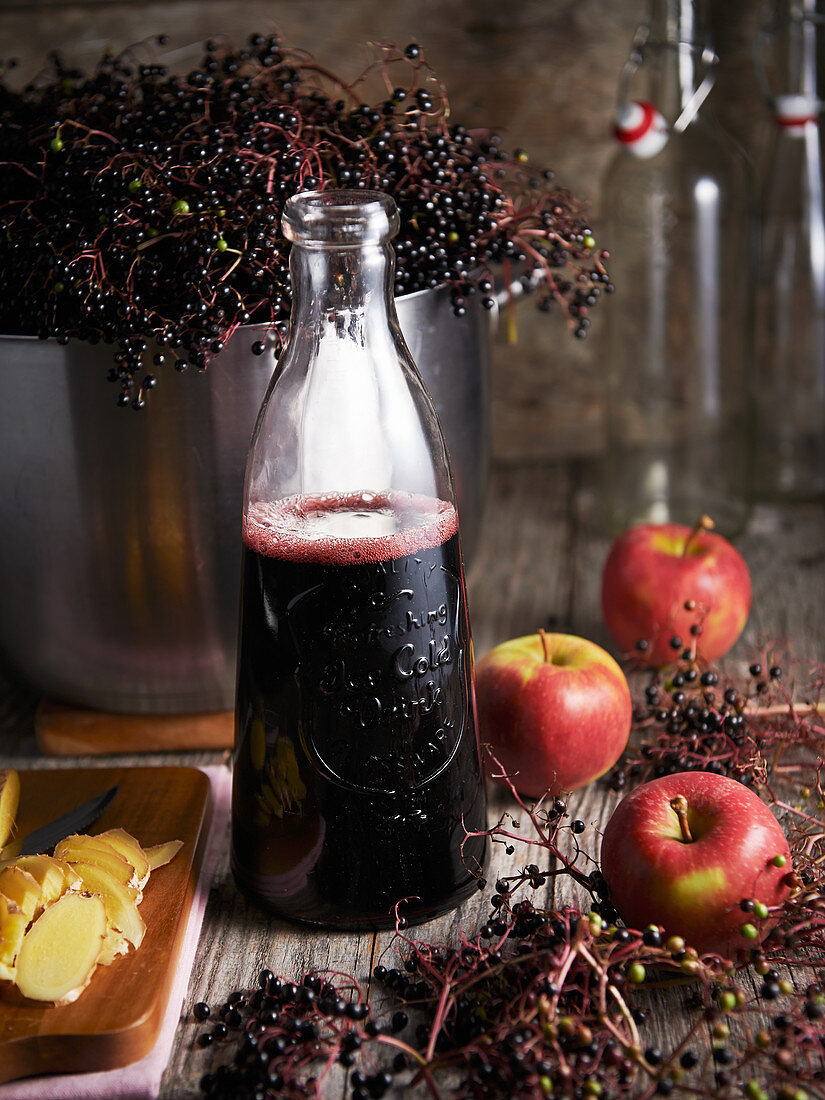 Apple and elderberry juice in a glass bottle