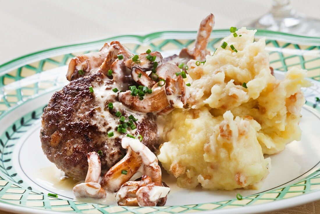 A veal meatball with chanterelle mushrooms and mashed potato