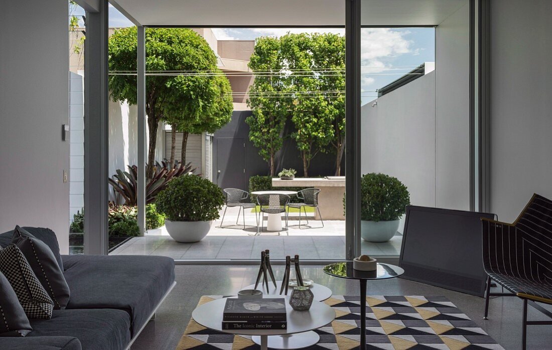 View from the modern living room into the courtyard garden