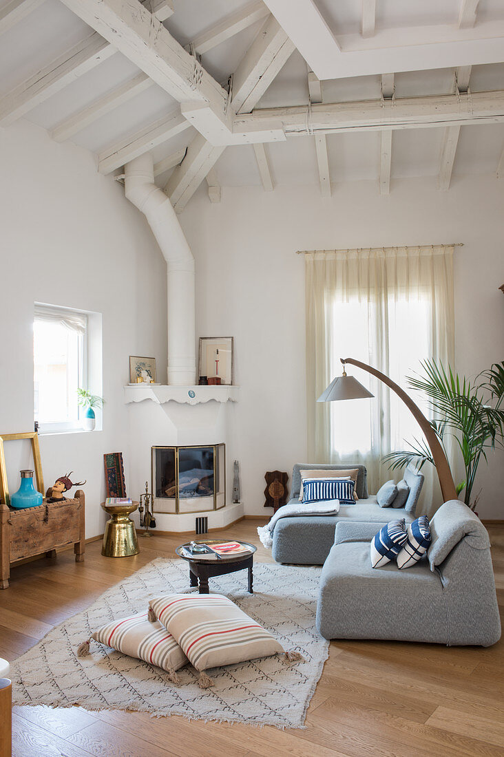 Modern easy chairs in Mediterranean living room with exposed roof structure