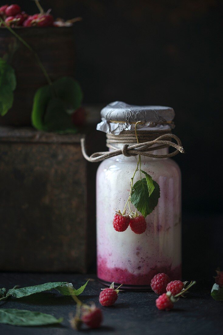 A vegan raspberry, banana and vanilla smoothie in a glass