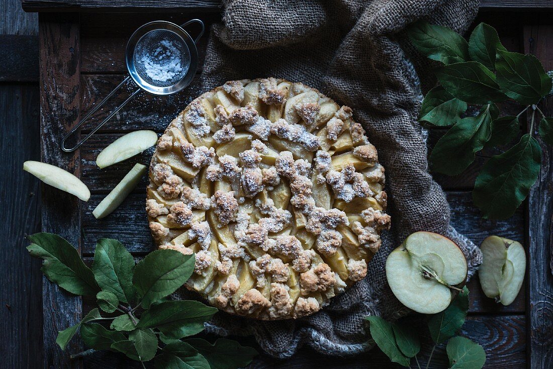 Vegan apple crumble cake on a rustic wooden background
