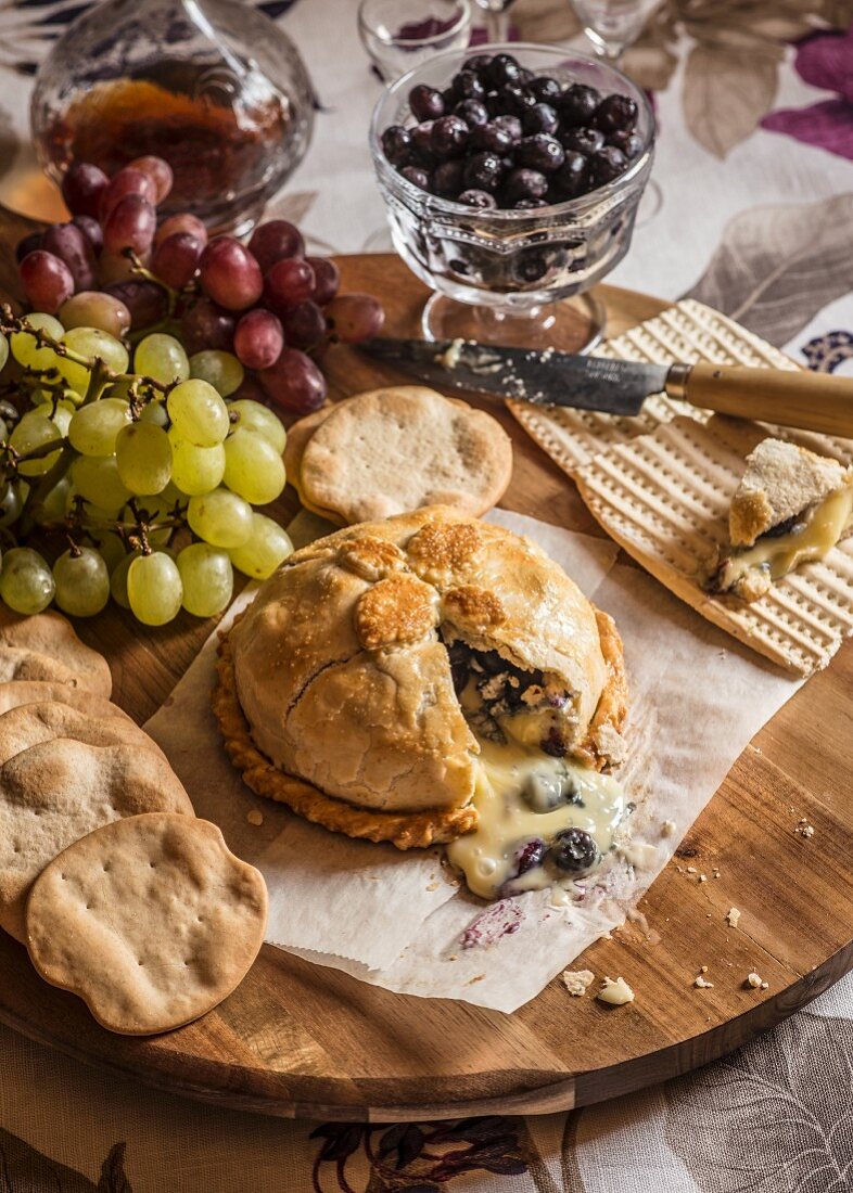 Brie en croute served with grapes and crackers