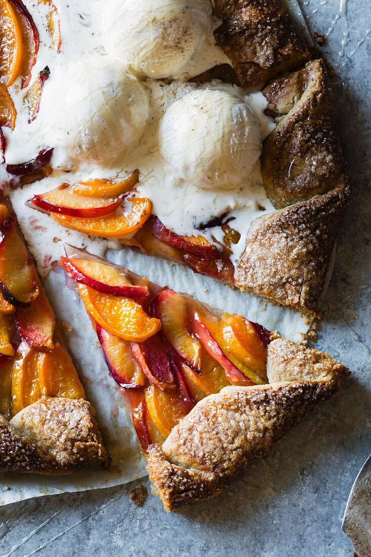 A galette with peach, nectarine and plum served with vanilla ice cream