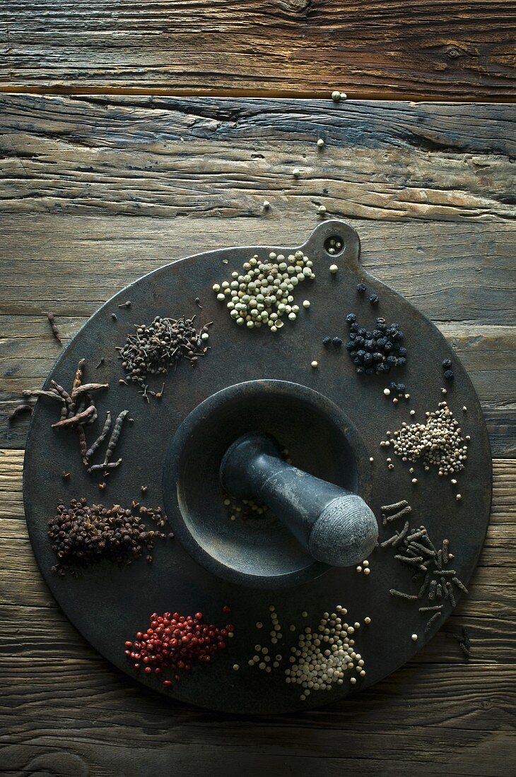 Various types of pepper on a round metal plate