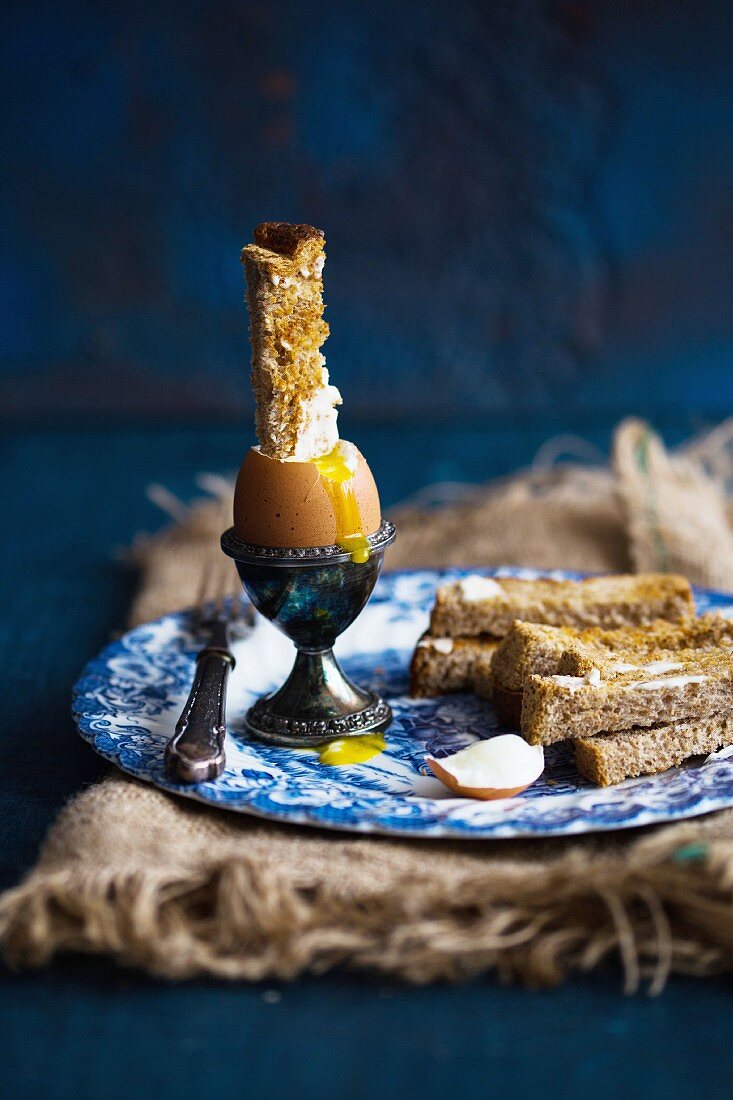 A soft-boiled egg and soldiers