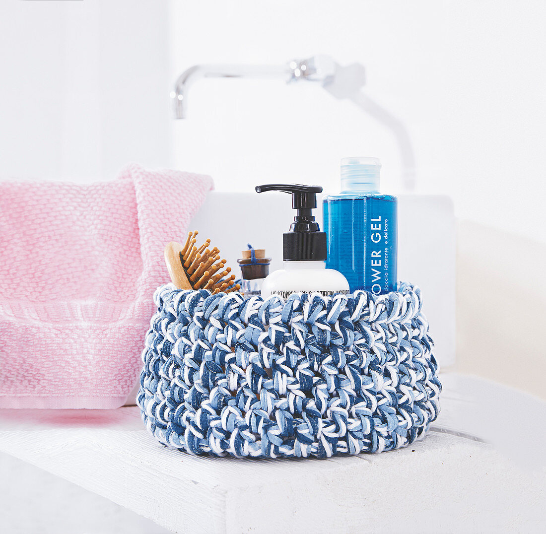 Crocheted bathroom basket in shades of blue