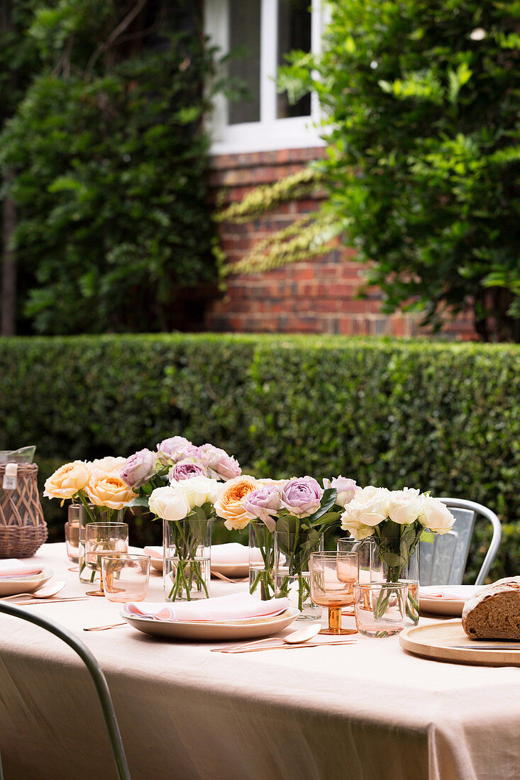 Small bouquets of flowers on the simply laid garden table