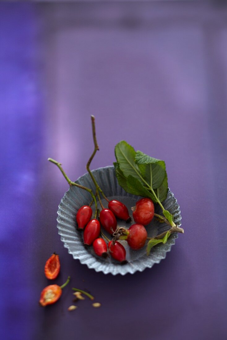 Fresh rosehips in a small baking tin