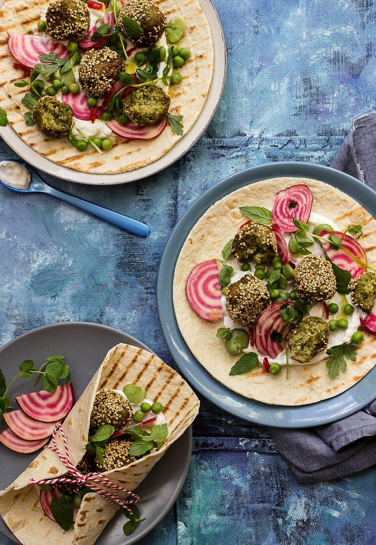 Wraps with broad bean and sesame falafel, yoghurt dressing, beetroot, peas, mint and parsley