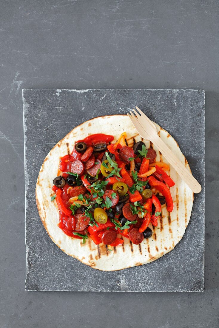 A tortilla wrap with chorizo and red pepper