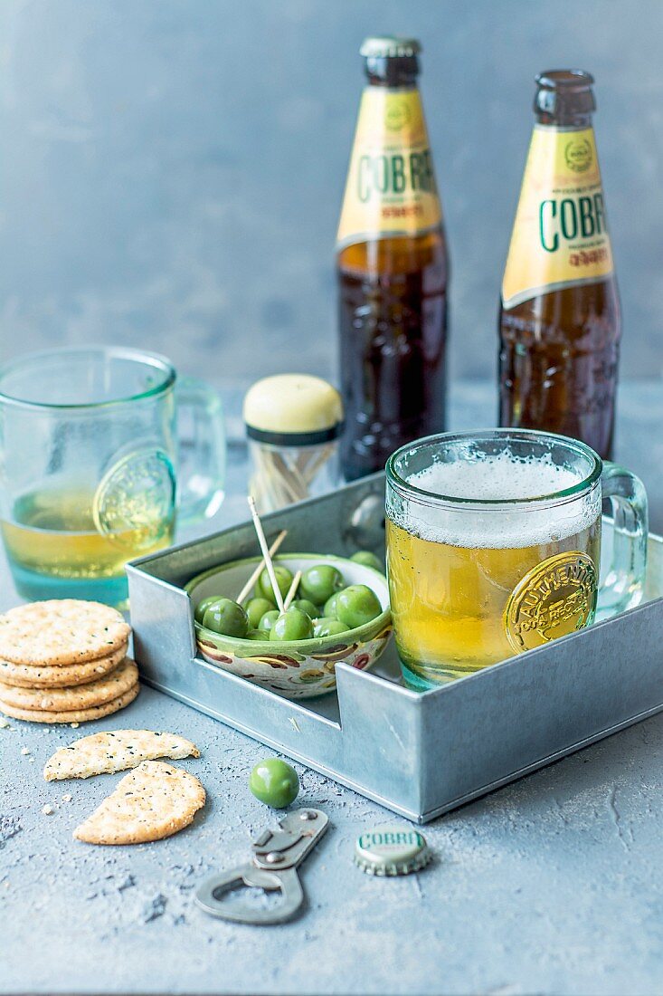 Green olives, crackers and beer